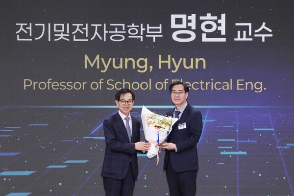 ▲KAIST 이광형 총장(왼쪽)으로부터 해외 바카라 사이트대상과 꽃다발을 전달받는 명현 전기및전자공학부 교수. (사진=KAIST)